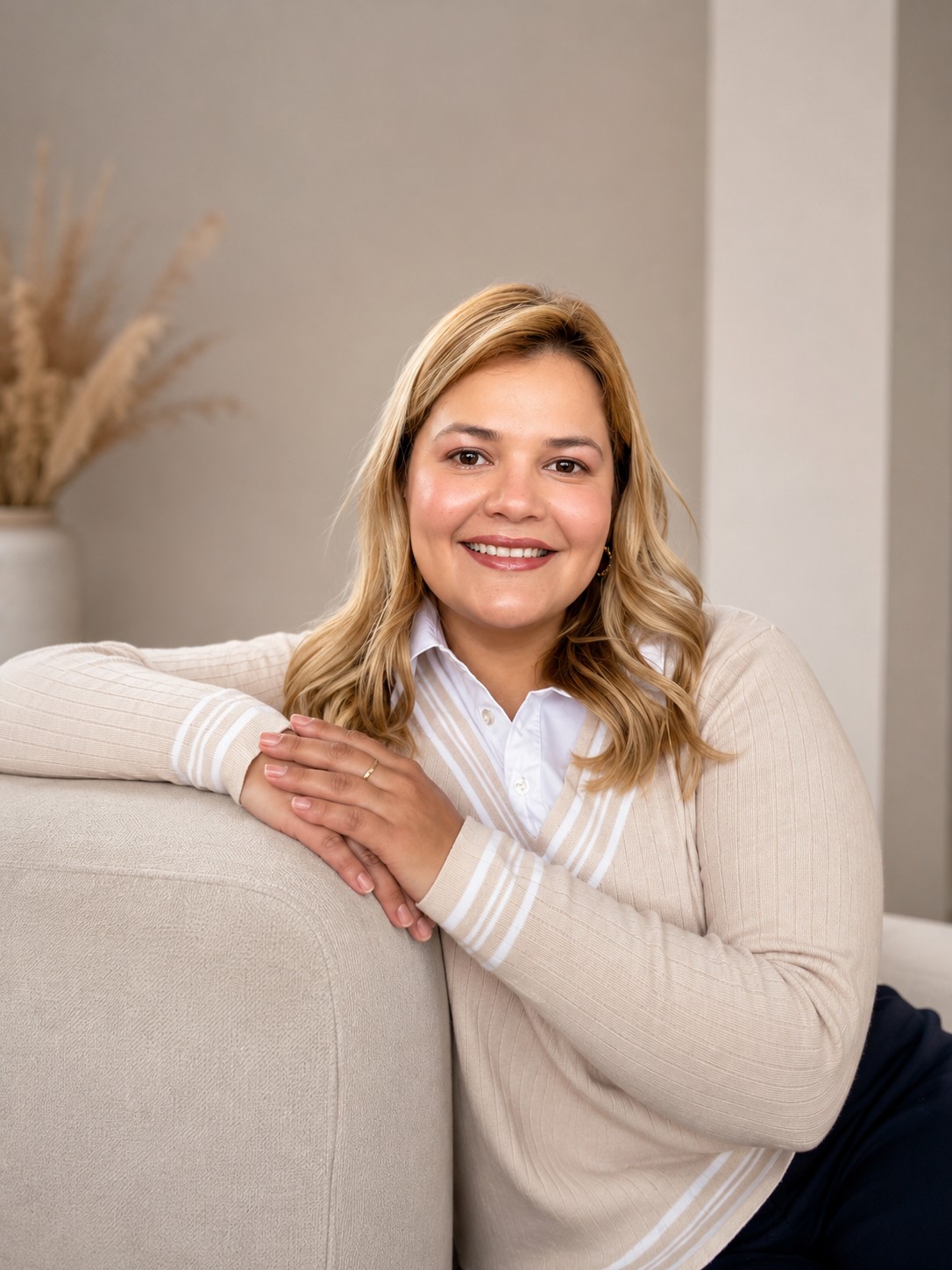 Daniela Ordoñez Rangel, psicóloga, sentada en un sofá beige